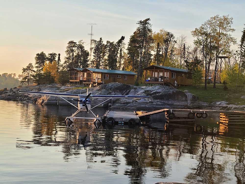 Group of cabins on the shore at Harrop Lake Wilderness Lodge, with a float plane in the foreground, Harrop Lake, Manitoba